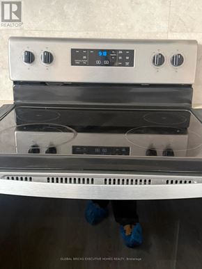Clarington (Bowmanville) townhouse for rent - A stainless steel oven with a digital control panel and four burners.