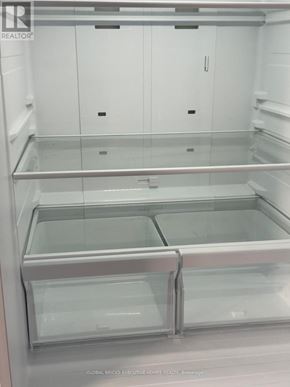 Clarington (Bowmanville) townhouse for rent - A clean, empty walk-in freezer with a glass door.