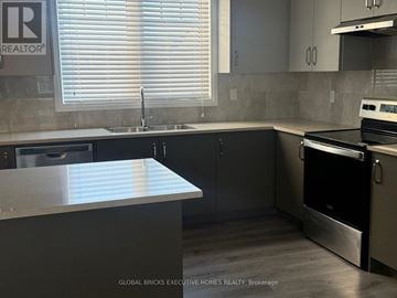Clarington (Bowmanville) townhouse for rent - A kitchen with a stainless steel oven and sink.