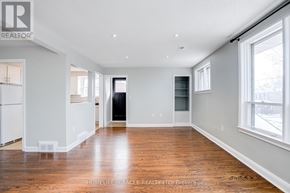Brampton (Downtown Brampton) apartment for rent - A spacious room with wooden floors and white walls.