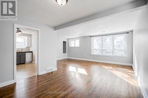 Brampton (Downtown Brampton) apartment for rent - A spacious room with wooden flooring and large windows.