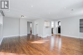 Brampton (Downtown Brampton) apartment for rent - A spacious room with wooden flooring and white walls.