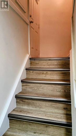 Brampton (Northwood Park) apartment for rent - A wooden staircase with a white wall on the side.
