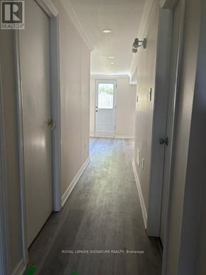 Mississauga (Erindale) apartment for rent - A hallway with white doors and a sign that says Royal LePage Signature Realty, Brokerage.