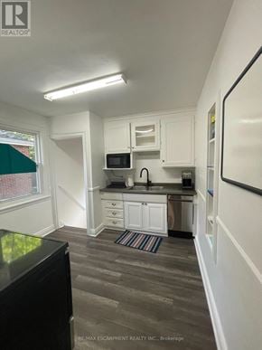 Hamilton (Ainslie Wood) apartment for rent - A kitchen with white cabinets and a black refrigerator.