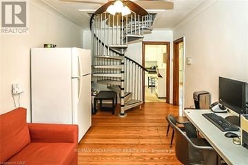 Hamilton (Ainslie Wood) apartment for rent - A living room with a red couch and a staircase.