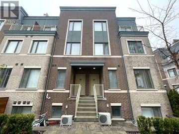 Toronto (New Toronto) townhouse for rent - A brick building with a balcony on the second floor.
