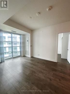 Toronto (Bayview Village) condo for rent - A large empty room with wooden floors and white walls.