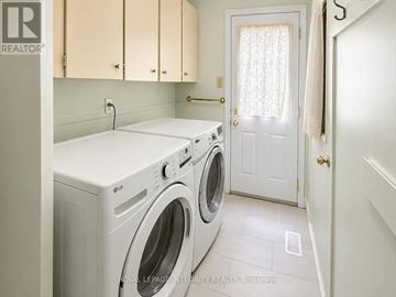 Ottawa apartment for rent - A white washing machine and dryer in a laundry room.