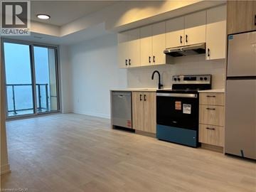 Burlington condo for rent - A kitchen with a refrigerator, stove, and oven.