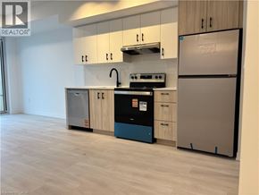 Burlington condo for rent - A kitchen with a refrigerator, oven, and stove.