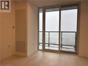 Burlington condo for rent - A room with a sliding glass door leading to a balcony.