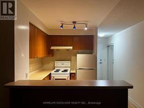 Toronto (Woburn) condo for rent - A kitchen with a stove and refrigerator in a small space.