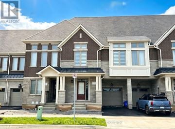 Oakville (Go Glenorchy) townhouse for rent - A large house with a car parked in front.