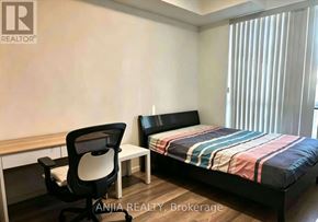 Richmond Hill (Doncrest) condo for rent - A bedroom with a bed, chair, and desk.