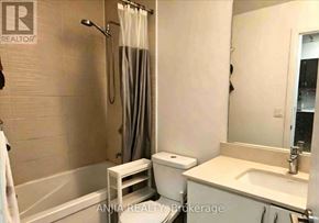 Richmond Hill (Doncrest) condo for rent - A bathroom with a white tub, toilet, and sink.