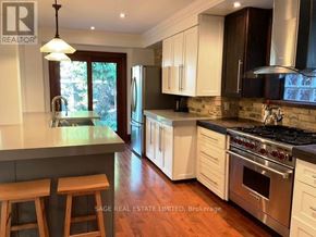 Toronto (Broadview North) apartment for rent - A kitchen with white cabinets and a wooden island.