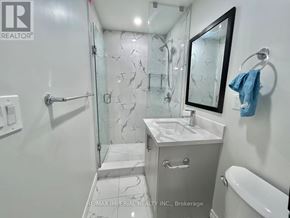 Toronto (L'amoreaux) apartment for rent - A bathroom with a marble tile shower and a white sink vanity.