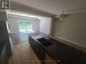 Kitchener townhouse for rent - A kitchen with a black counter top and a window.