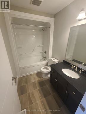 Kitchener townhouse for rent - A bathroom with a walk in shower, toilet and sink.