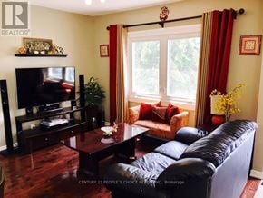 Toronto (Oakwood Village) apartment for rent - A living room with a black leather couch and a wooden coffee table.