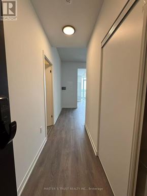Burlington (Alton) condo for rent - A long hallway with wood floors and white walls.