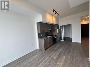 Burlington (Alton) condo for rent - A kitchen area with a refrigerator, microwave, and oven.