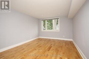Toronto (Willowdale West) apartment for rent - A room with wooden flooring and a window showing trees outside.
