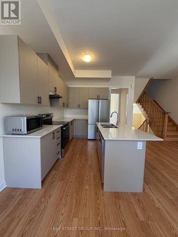 Richmond Hill townhouse for rent - A kitchen with white cabinets and a microwave on top of the counter.