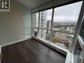 Coquitlam apartment for rent - A room with a large window overlooking a cityscape.