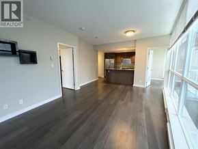 Coquitlam apartment for rent - A living room with a dark wood floor and white walls.