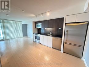 Toronto (Waterfront Communities) condo for rent - A kitchen with a refrigerator, dishwasher, and oven.