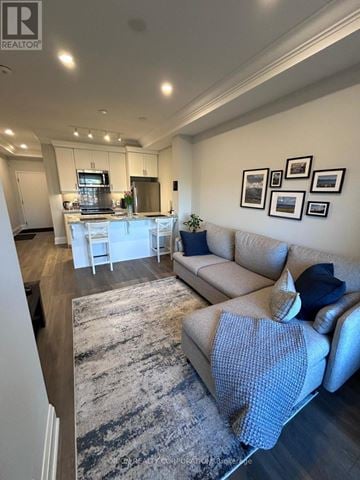 Burlington (Tansley) condo for rent - A living room with a grey rug and a grey sofa.