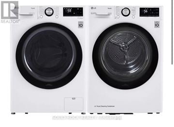 Ottawa townhouse for rent - Two white front loading washing machines with the door open.