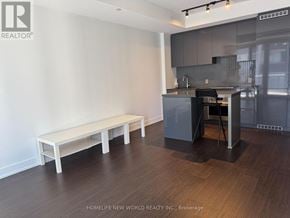 Toronto (Bay Street Corridor) condo for rent - A kitchen with a refrigerator, sink, and stove.