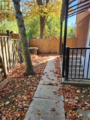 Toronto (Rouge) apartment for rent - A sidewalk with leaves on it and a tree in the background.