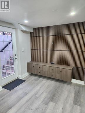 Toronto (Rouge) apartment for rent - A room with a wooden floor and a wooden wall paneling.