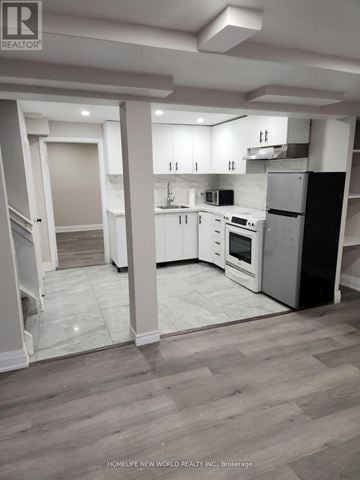 Toronto (Rouge) apartment for rent - A modern kitchen with white appliances and cabinets.