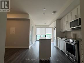 Oakville (Jm Joshua Meadows) condo for rent - A spacious kitchen with a stove top oven and microwave.