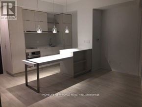 Toronto (Church-Yonge Corridor) condo for rent - A modern kitchen with a white countertop and a bar stool.