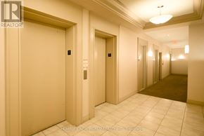 Toronto (Willowdale East) condo for rent - A hallway with two doors and a brokerage logo.