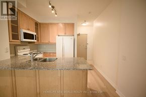 Toronto (Willowdale East) condo for rent - A kitchen with wooden cabinets and a granite countertop.