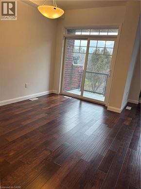 Ancaster townhouse for rent - A room with wooden flooring and a sliding glass door.