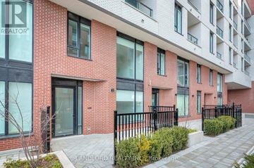 Toronto (Downsview-Roding-Cfb) condo for rent - A red brick building with black railings and windows.