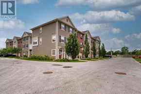 London North (North I) townhouse for rent - A large apartment complex with a parking lot in front.