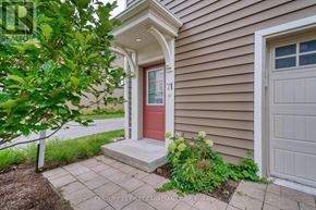 London North (North I) townhouse for rent - A house with a red door and a tree in front.