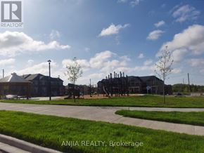 Pickering townhouse for rent - A sunny day at Brokerage with a building and a playground.
