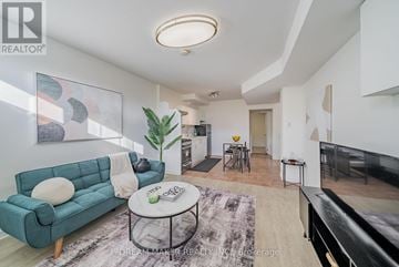Oshawa (Vanier) townhouse for rent - A living room with a blue couch and a coffee table.