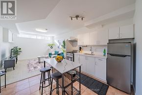Oshawa (Vanier) townhouse for rent - A kitchen with white cabinets and a stainless steel refrigerator.