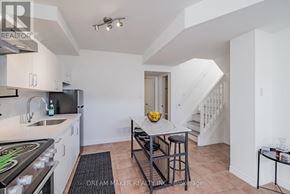 Oshawa (Vanier) townhouse for rent - A kitchen with white cabinets and a black stove top oven.